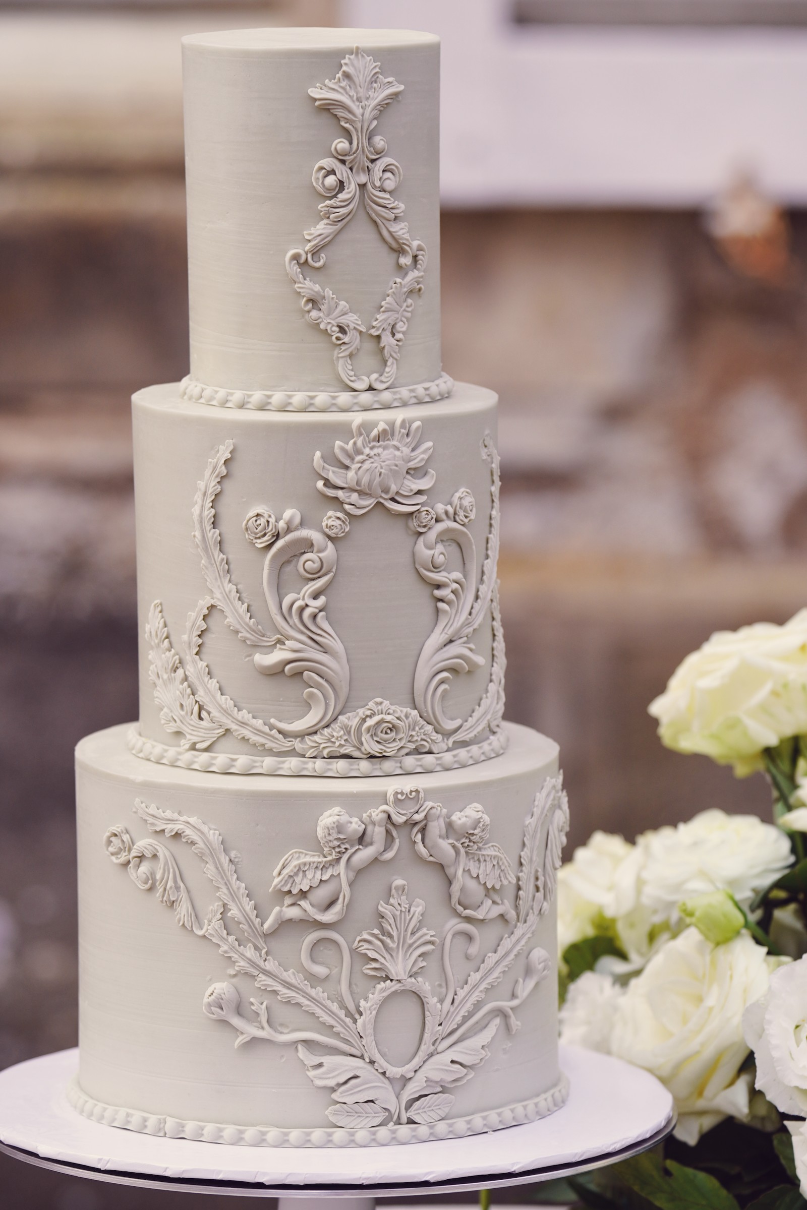French grey three-tier wedding cake with baroque piping at Château de Bouthonvilliers