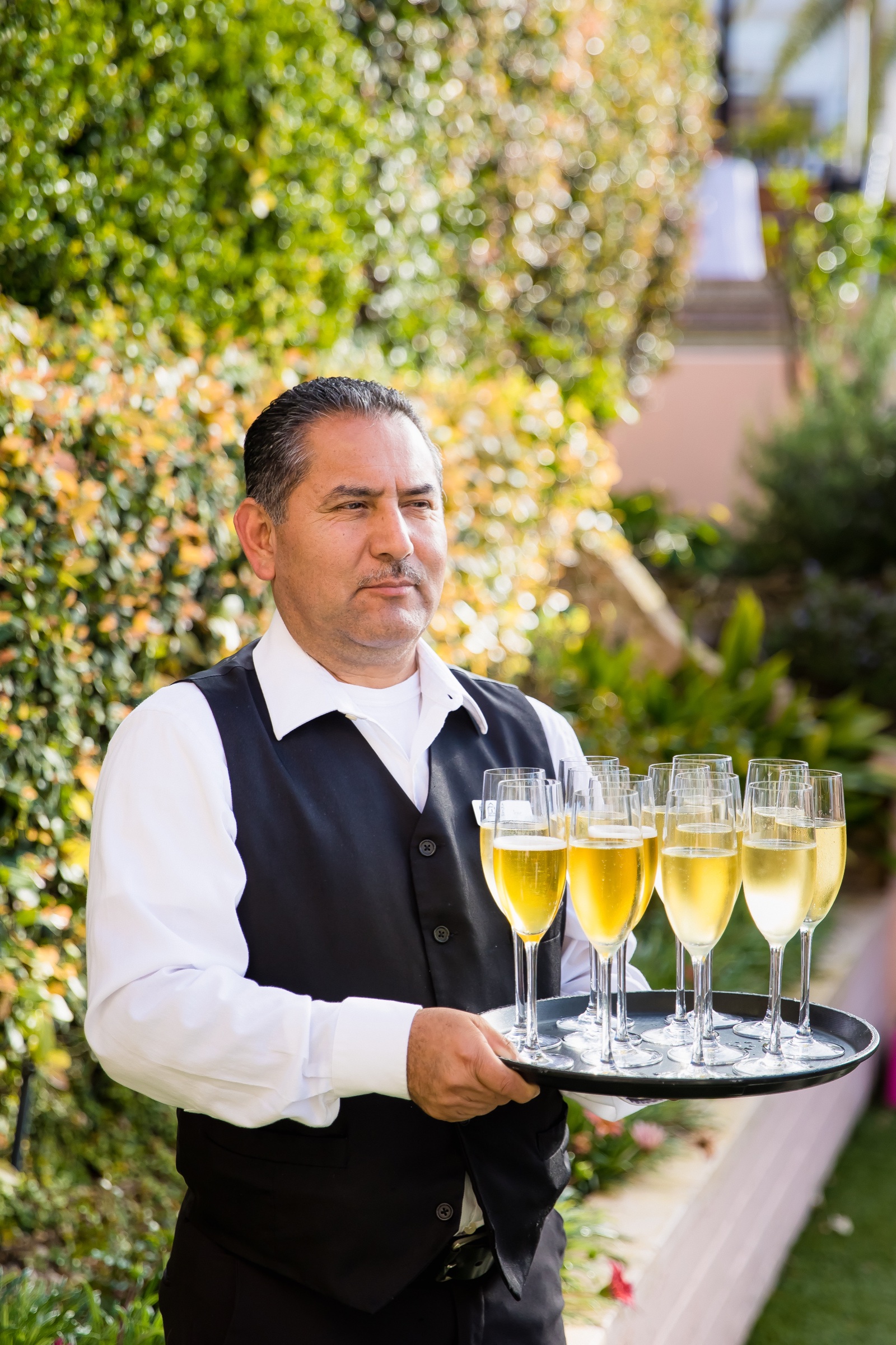 Champagne passed on a silver tray in the garden at a La Valencia Hotel wedding