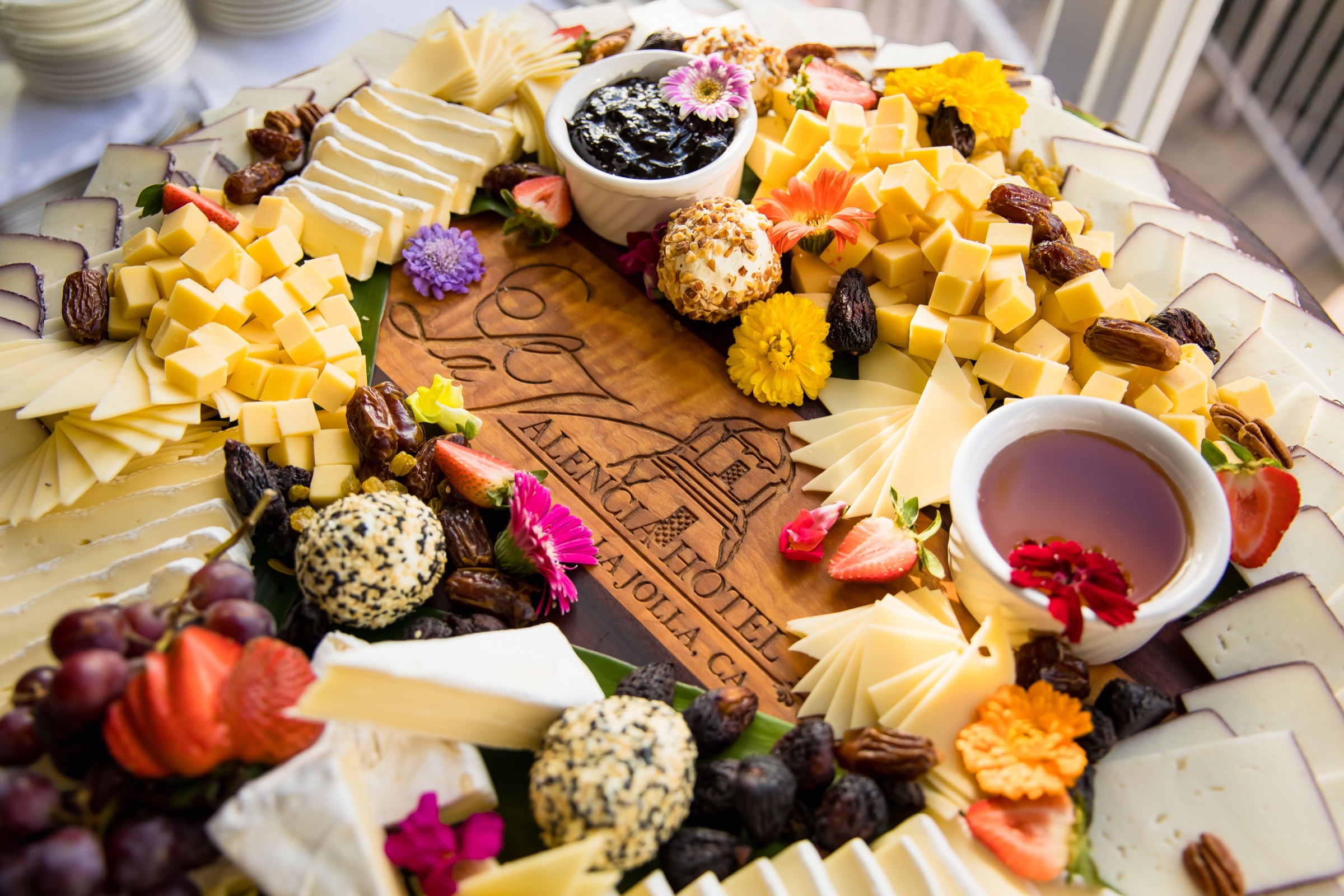 Carved cheese board with edible flowers at a La Valencia Hotel cocktail hour
