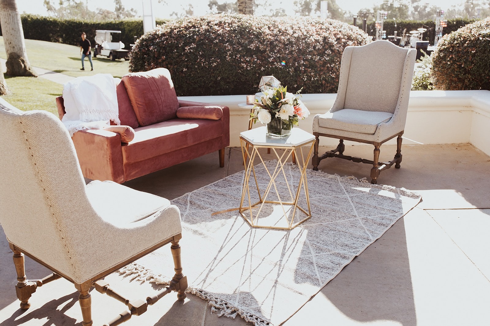 Blush velvet loveseat, wingback chairs, and a gold side table in the reception lounge at Park Hyatt Aviara